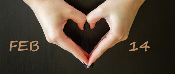 February 14 valentines day symbol. Woman making heart shape on dark background. Words Feb 14. Heart...