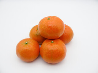 Five orange fresh tangerines on a white background.