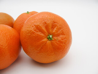 Orange fresh tangerines on a white background. Tangerine up close.