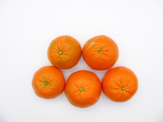 Five orange fresh tangerines on a white background. Top view.