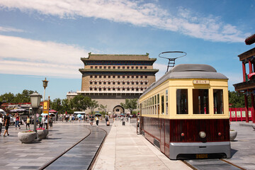 Touristic tram near historical Zhengyangmen gate in the center of Beijing, China.