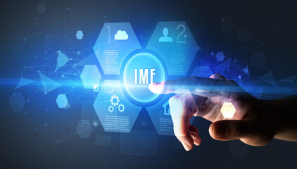 Hand touching IMF inscription, new technology concept