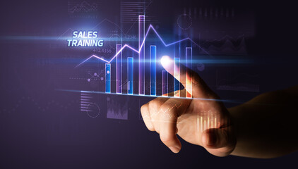 Hand touching SALES TRAINING button, business concept