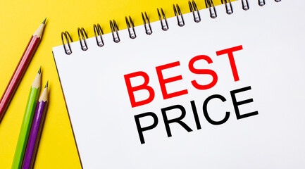 BEST PRICE on a white notepad with pencils on a yellow background. Business concept