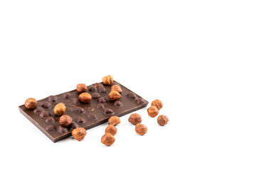 Appetizing chocolate with whole hazelnuts on a white background