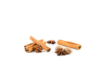 Anise stars with cinnamon sticks and nutmeg on a white background, fragrant tea additives