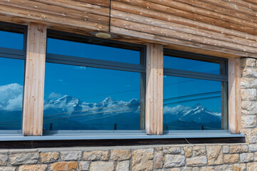 Fototapeta na wymiar reflection in the window of the Swiss Alps