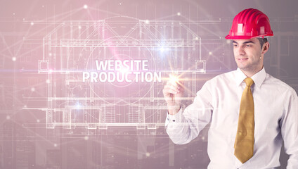 Handsome architect with helmet drawing WEBSITE PRODUCTION inscription, new technology concept