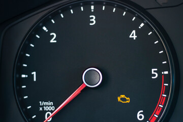 Natural light. the dashboard of the car. The engine error indicator lights up on it. Close-up.
