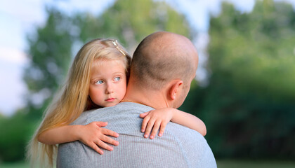 Fototapeta premium Little blonde sad daughter hugging his dad