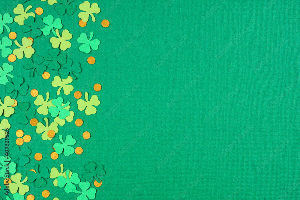 Poster St Patricks Day green background with shamrock and gold coin confetti side border. Top down view with copy space.