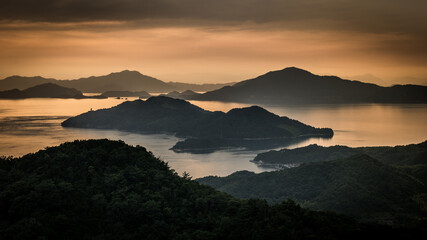 Fototapeta na wymiar Sunset over islands and mountains