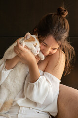 Young woman enjoying her cat at home
