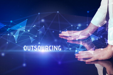 Businessman touching huge screen with OUTSOURCING inscription, modern technology business concept