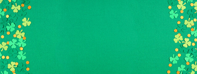 St Patricks Day green background with shamrock and gold coin confetti double border. Top view banner with copy space.