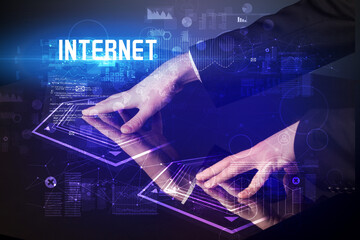 Hand touching digital table with INTERNET inscription, new age security concept