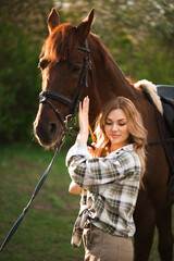 Obraz premium Beautiful girl with her horse and beautiful warm sunset in the spring forest.