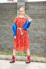 Portrait of a stylish model in long red flowers dress