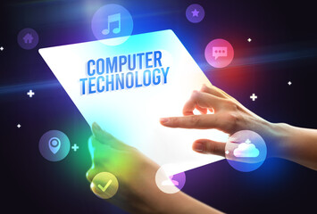 Holding futuristic tablet with COMPUTER TECHNOLOGY inscription, new technology concept