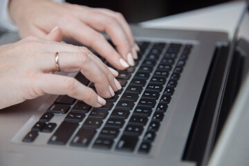 Work from home, e-learning, online learning concept. Close-up, business woman working, hand typing on laptop computer, searching the internet at the table in modern home office. Student studying at ho