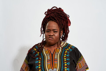 Angry plump young woman with squinted eyes