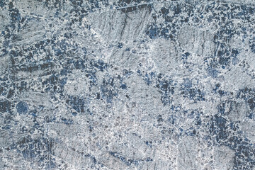 Light grey stone wall with dark blue abstract pattern texture background