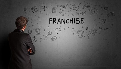 businessman drawing a creative idea sketch with FRANCHISE inscription, business strategy concept