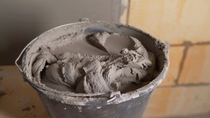 Bucket with mortar at consturction site. Bucket with mortar.