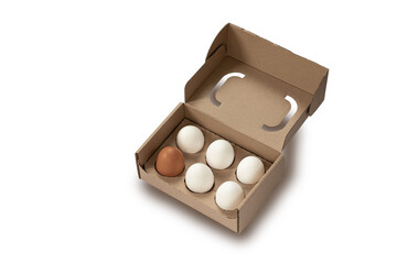 Close-up view of raw chicken eggs in egg box on white wooden background