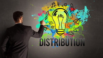 businessman drawing colorful light bulb with DISTRIBUTION inscription on textured concrete wall, new business idea concept