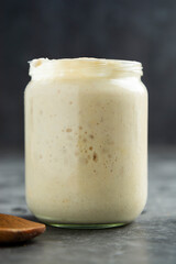 Sourdough in a glass jar. Cooking homemade, rustic sourdough bread.
