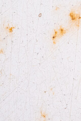 Textured surface made of rust and cracked white paint