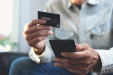 Digital banking, Online shopping, internet payment concept, Man using mobile phone and credit card for  internet payment via mobile banking app.