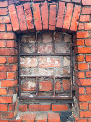 Old historical metal window covered with bricks. Gniew City Poland
