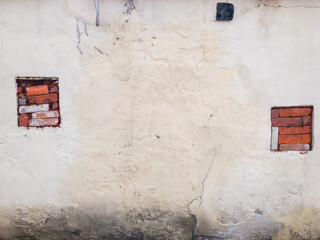 old wall with two windows filled with bricks. Empty background. Empty middle space
