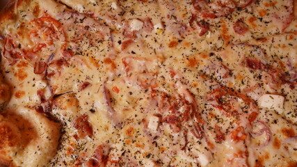 Close up of large pizza with different ingredients. Texture of appetizing pizza with various fillings.