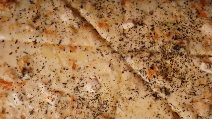 Close up of large pizza with different ingredients. Texture of appetizing pizza with various fillings.