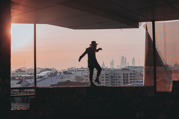 
girl walks along the edge of the balcony