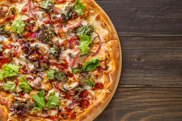 Fresh pizza with tomato sauce, black olives, mozzarella cheese, ham on wooden table closeup. Space for text or copy space. Pizza menu. Restaurant menu advertise