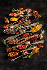 Various spices a vintage spoons on stone table. Colorful Herbal and Spices Oriental marketplace.Top view . Cafe concept. Delicious food delivery.