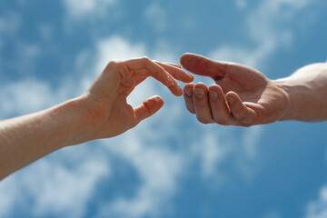 Hands on sky background. Couple, love, together.
