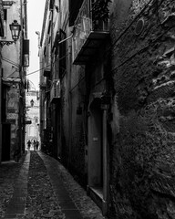 Black and white image of a narrow alley in Tropea historic center, Calabria, Italy