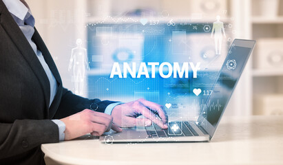 Doctor working a health check with ANATOMY inscription, recording medical test results