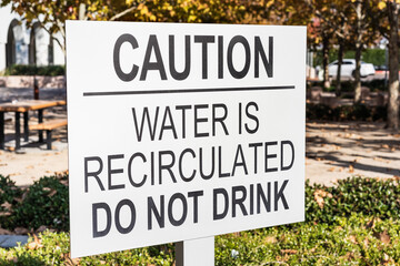 Close up of 'Caution / Water is recirculated / do not drink' sign; San Francisco Bay Area, California