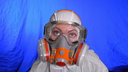 Scientist virologist in respirator. Slow motion. Woman close up look wearing protective medical mask. Concept health safety N1H1 virus protection coronavirus epidemic 2019 nCoV. Chroma key blue film.