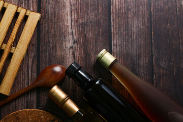 Cooking oil on top of wooden table for background.