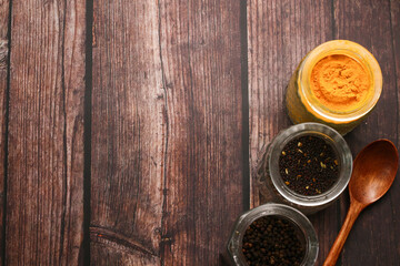 Cooking spices and olive oil on top of wooden table.
