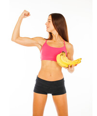 Portrait of a young sports girl with bananas