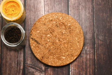 Spices for cooking and wooden table as background.