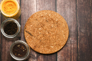Spices for cooking and wooden table as background.